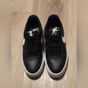 Nike Women's Court Vision Alta leather platform sneakers in black and white. 